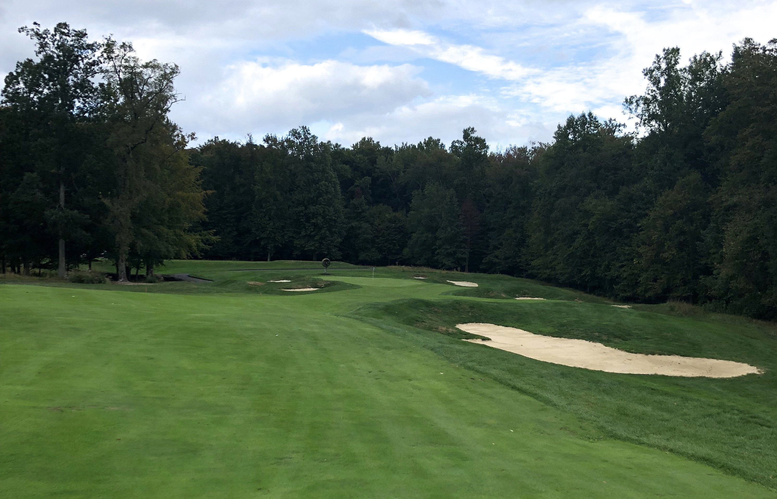 The approach to the 14th green at Bulle Rock Golf, showcasing the narrow green and surrounding bunkers.