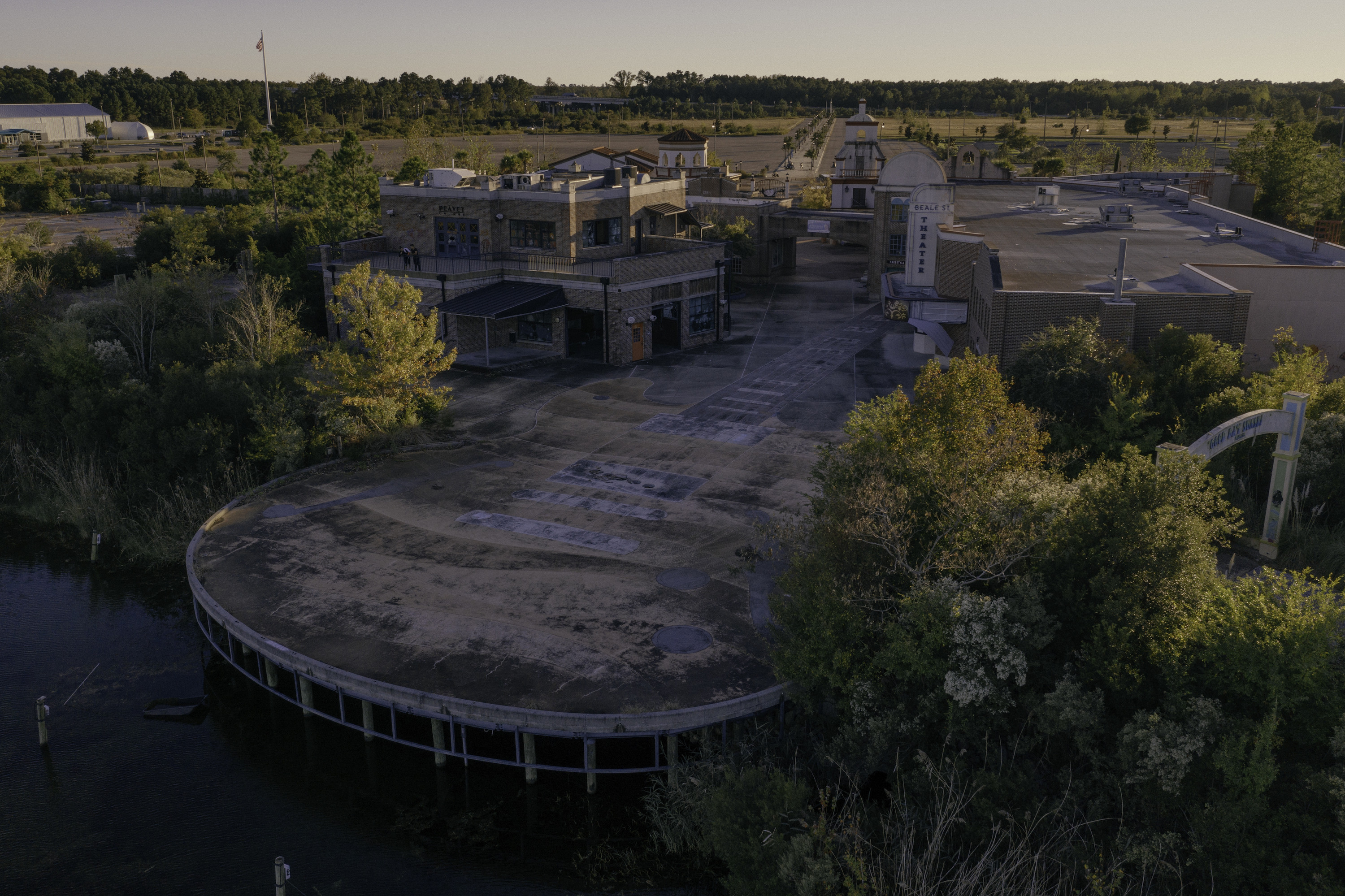 Jim Burton Standing Outside the Gates of the Abandoned Hard Rock Park, Reflecting on its Past