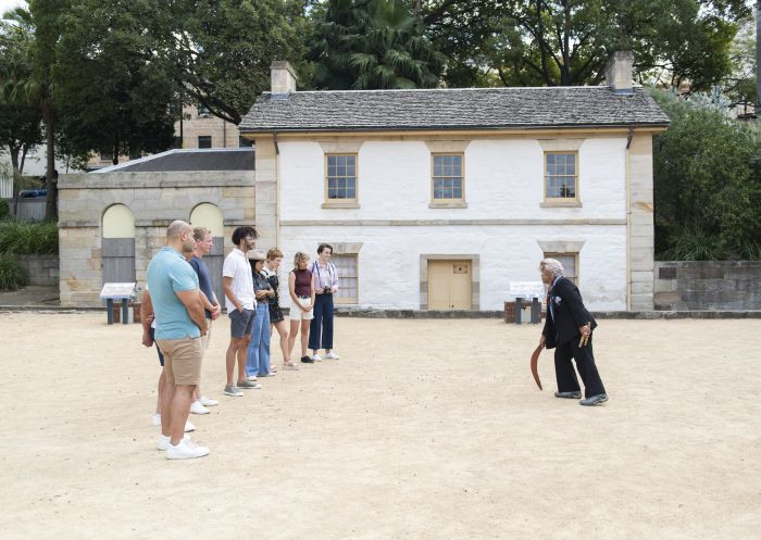 Margret Campbell guides a group on The Rocks Aboriginal Dreaming Tour, showcasing indigenous heritage within the historic precinct of Sydney.