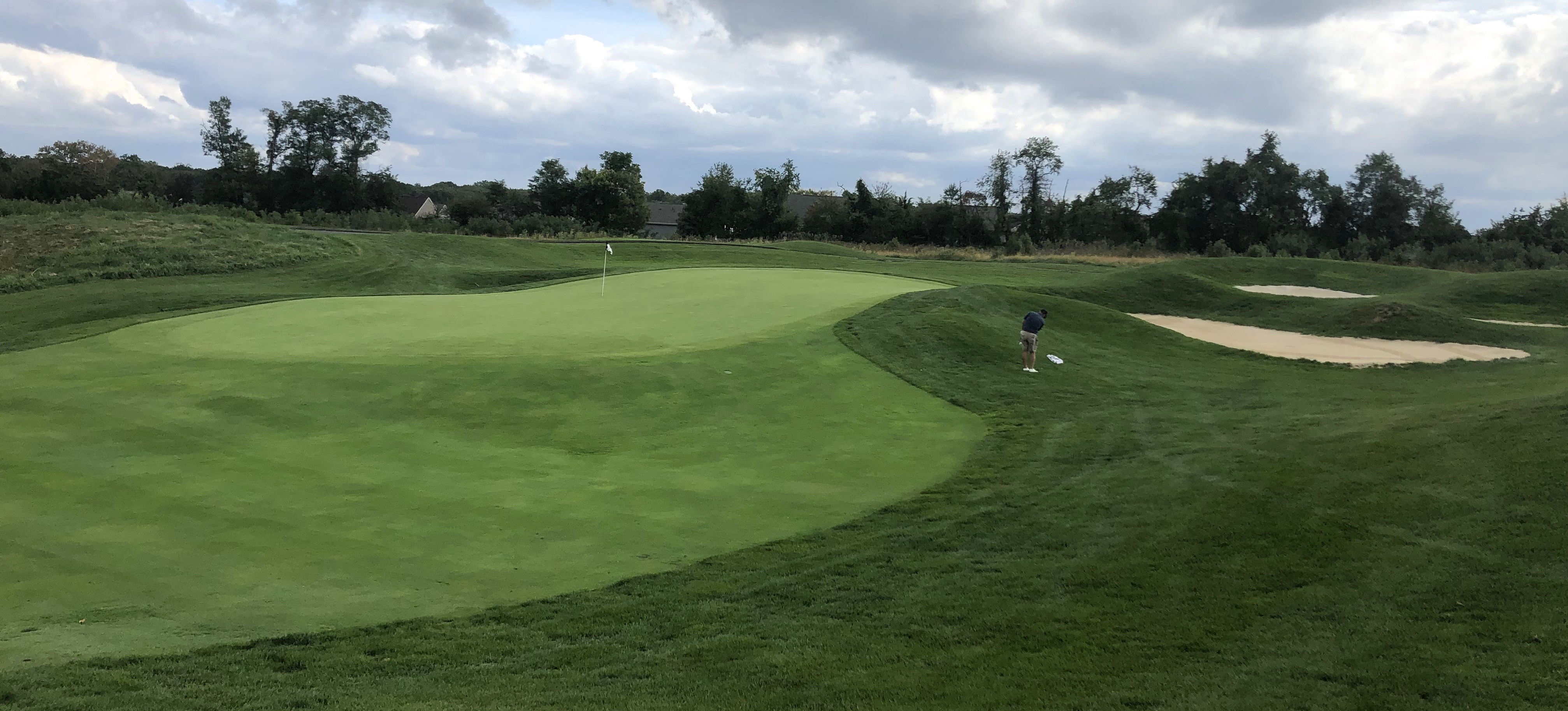 The 5th green at Bulle Rock Golf, illustrating the typical narrow, undulating putting surface protected by bunkers.