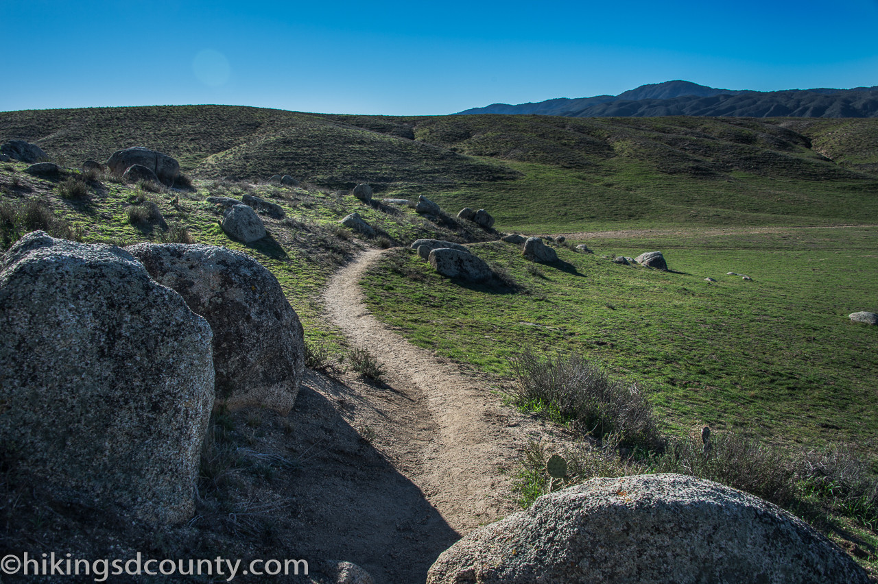 Green grassy hills and scattered boulders near Eagle Rock