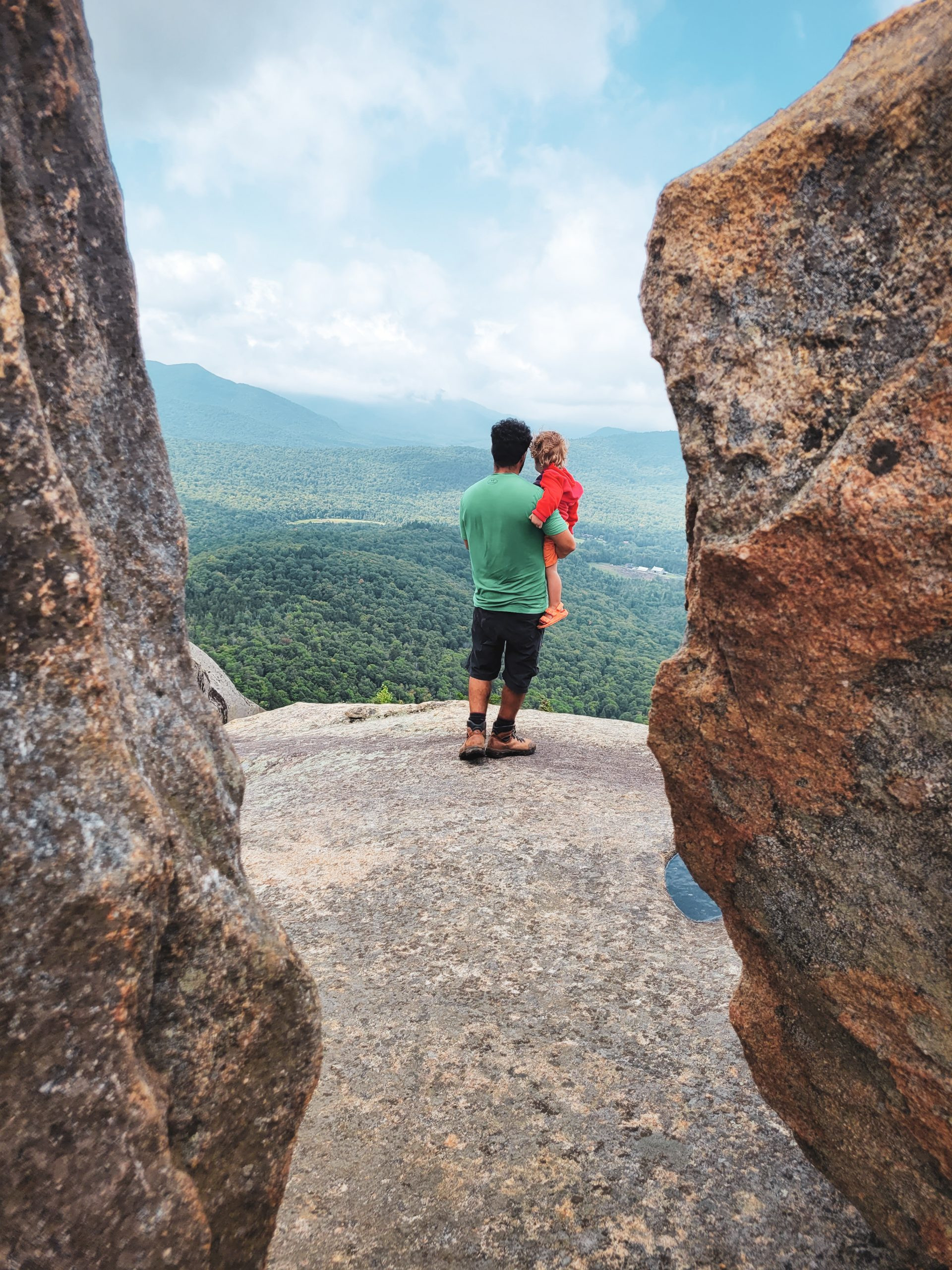 Panoramic views between the Balanced Rocks formations, showcasing the surrounding Adirondack landscape.