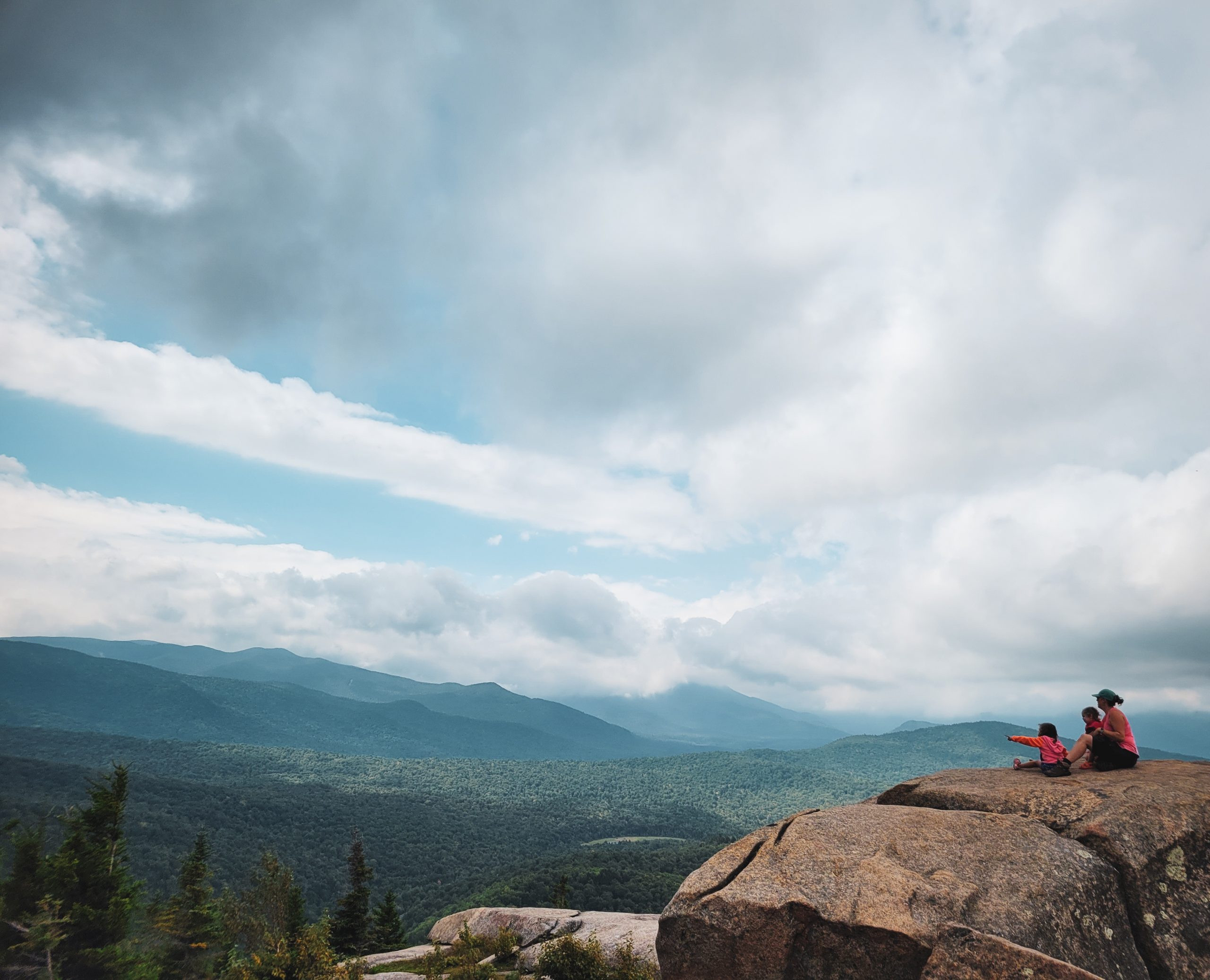 Our family, silhouetted against the stunning Adirondack scenery, celebrates reaching the Balanced Rocks.