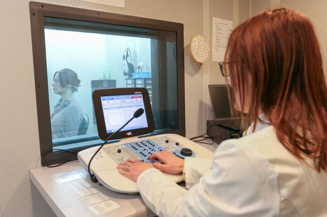 Dr. Ann Perreau, Audiology Clinic coordinator, working with a client at Augustana College Rock Island