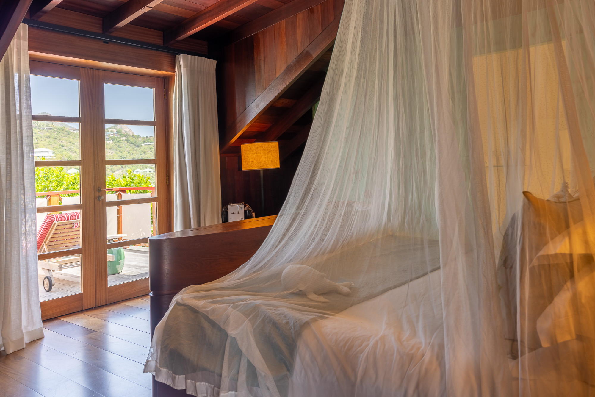 Living area of Eden Rock St Barths suite, showcasing stylish furniture and ocean views.