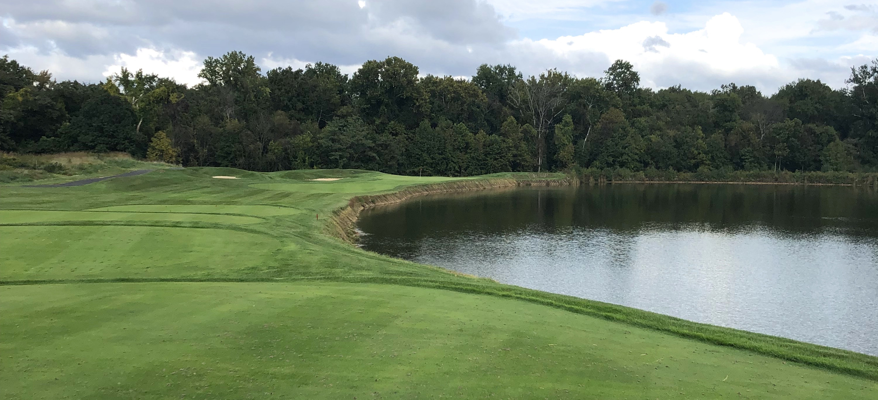 Bulle Rock Golf's par 3 12th hole, a signature hole with a dramatic water carry and strategically bunkered green.