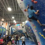 Climbers at The Cliffs Long Island City, a top rock climbing gym in NYC.