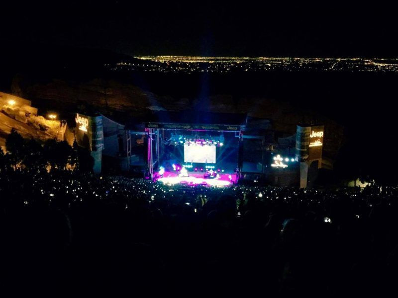 Backup singers dancing energetically on stage at Red Rocks Amphitheatre, showcasing the lively and engaging performances at the venue.