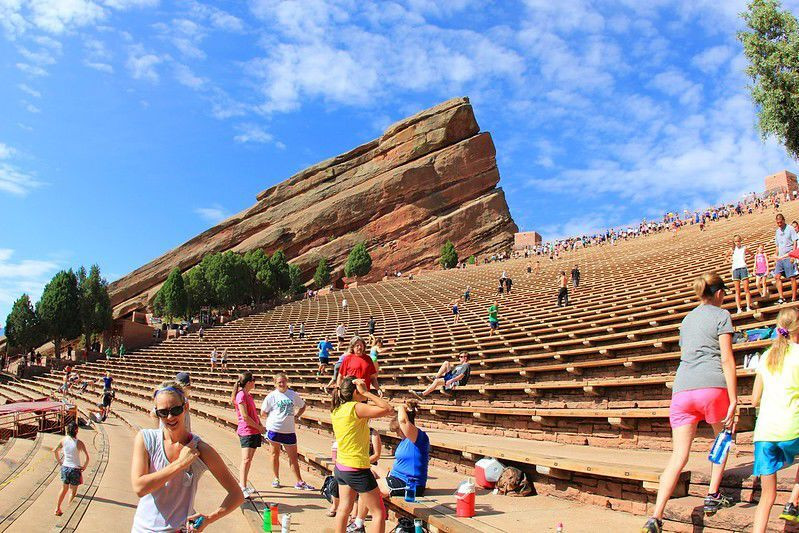 People exercising on the steps of Red Rocks Amphitheatre, showcasing the venue's use for fitness and recreational activities.