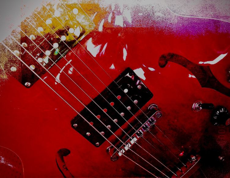 Electric guitar leaning against an amplifier, symbolizing rock music genres