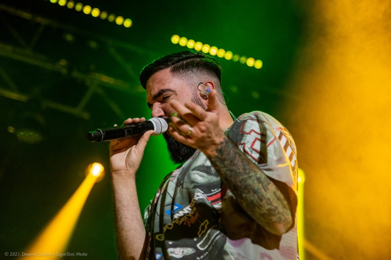 Jeremy McKinnon of A Day to Remember performing at Blue Ridge Rock Festival Day 1. The vocalist is engaging with the audience, singing and gesturing dynamically on stage.