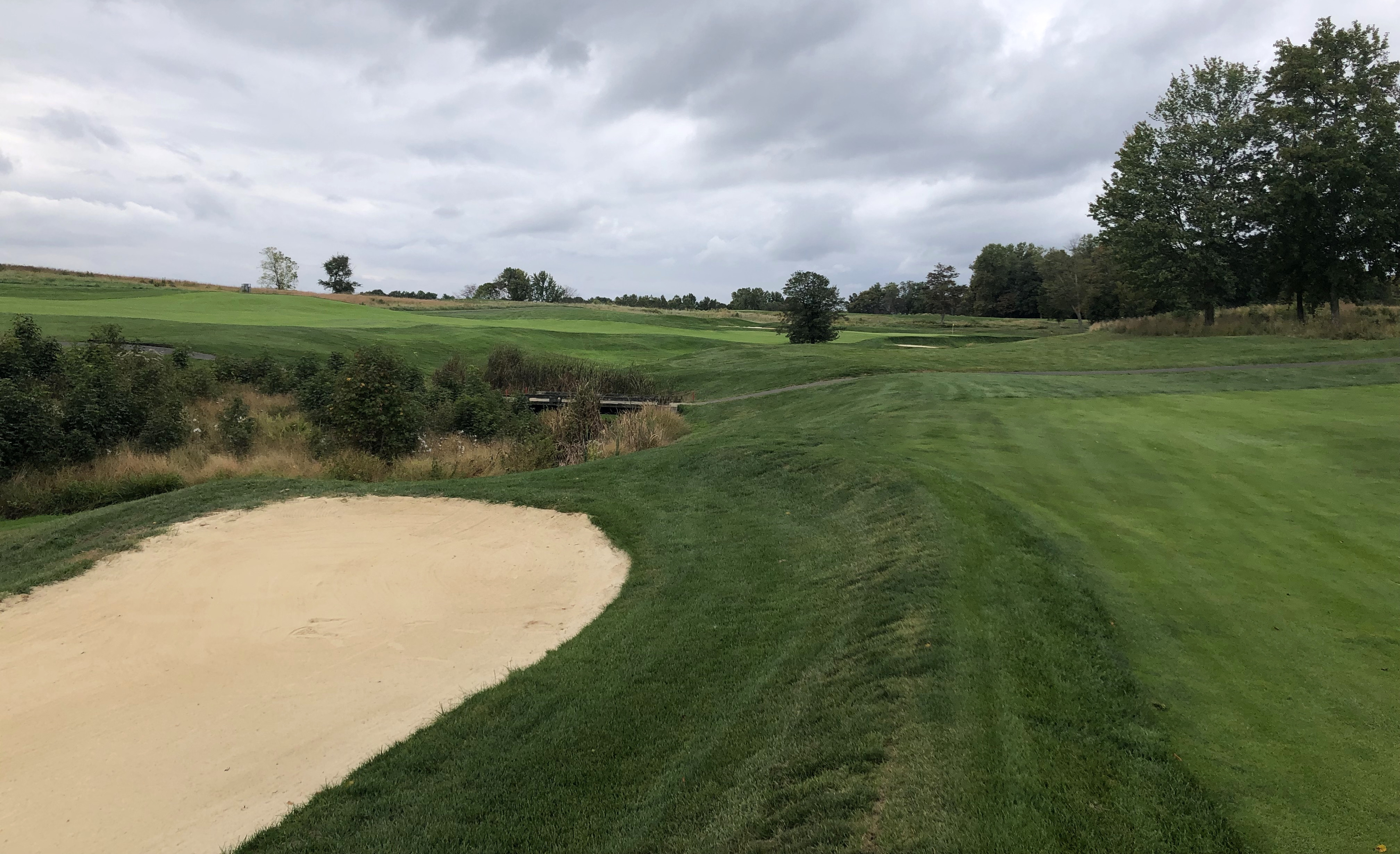 The second shot view at Bulle Rock Golf's 15th hole, highlighting the split fairway and strategic choices for golfers.