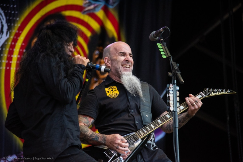 Joey Belladonna and Scott Ian of Anthrax performing together at Blue Ridge Rock Festival Day 2. The singer and guitarist are interacting on stage during their performance.