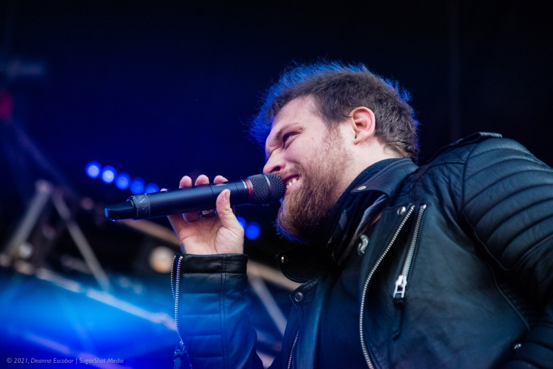 Danny Worsnop of Asking Alexandria singing at Blue Ridge Rock Festival Day 2. The Asking Alexandria vocalist is delivering a powerful vocal performance on stage.