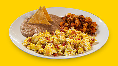 Crispy bacon and egg breakfast plate at Taco Palenque Round Rock, featuring bacon, eggs, beans, and tortillas.