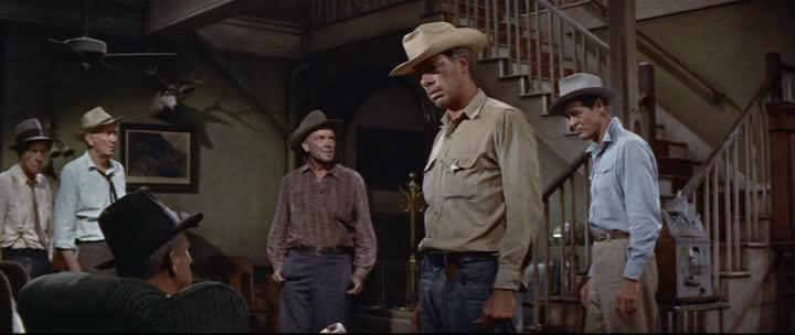 Tense confrontation in 'Bad Day at Black Rock' featuring Robert Ryan, Lee Marvin, and Spencer Tracy, showcasing the film's thriller elements.