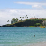 People cliff jumping from Black Rock, Pu'u Keka'a, in Maui, Hawaii.