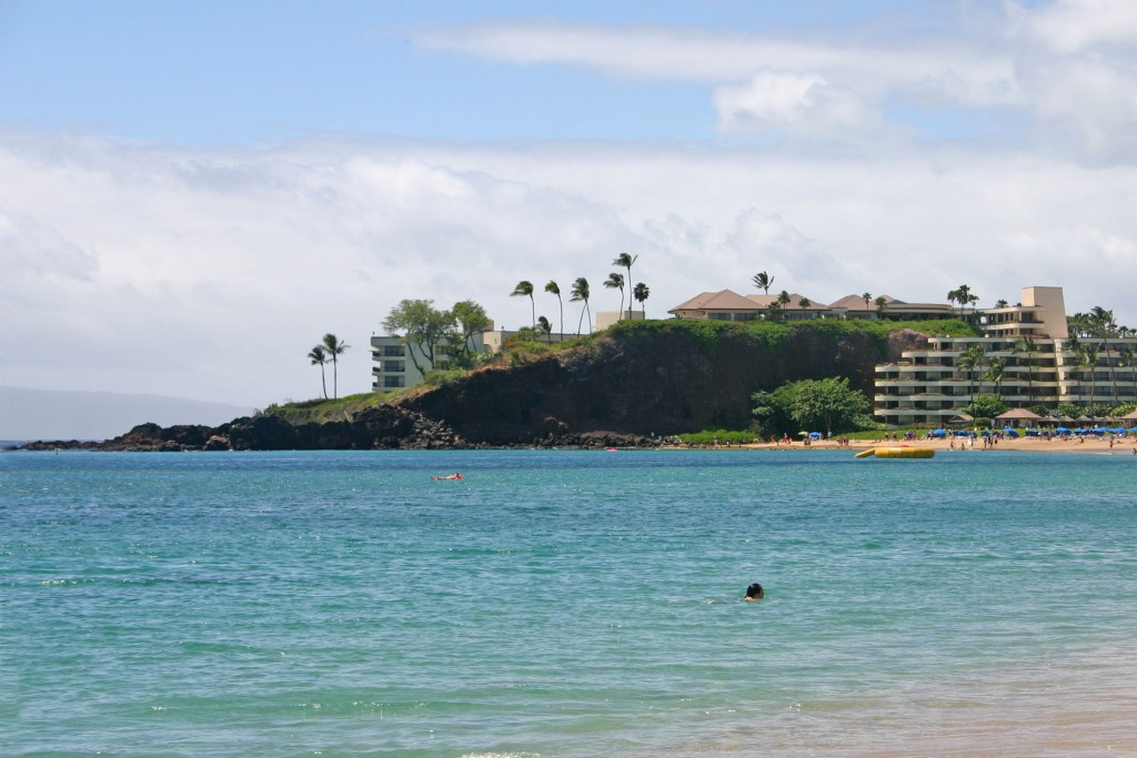 People cliff jumping from Black Rock, Pu'u Keka'a, in Maui, Hawaii.