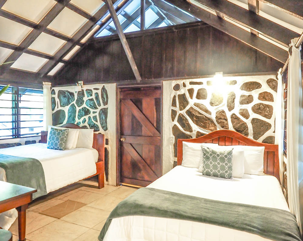 Two beds inside a cozy jungle cabin at Black Rock Lodge Belize