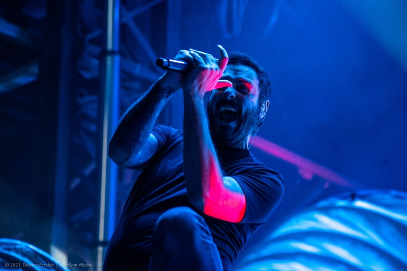 Benjamin Burnley of Breaking Benjamin performing at Blue Ridge Rock Festival Day 1. The singer and guitarist is intensely focused on his performance under stage lighting.