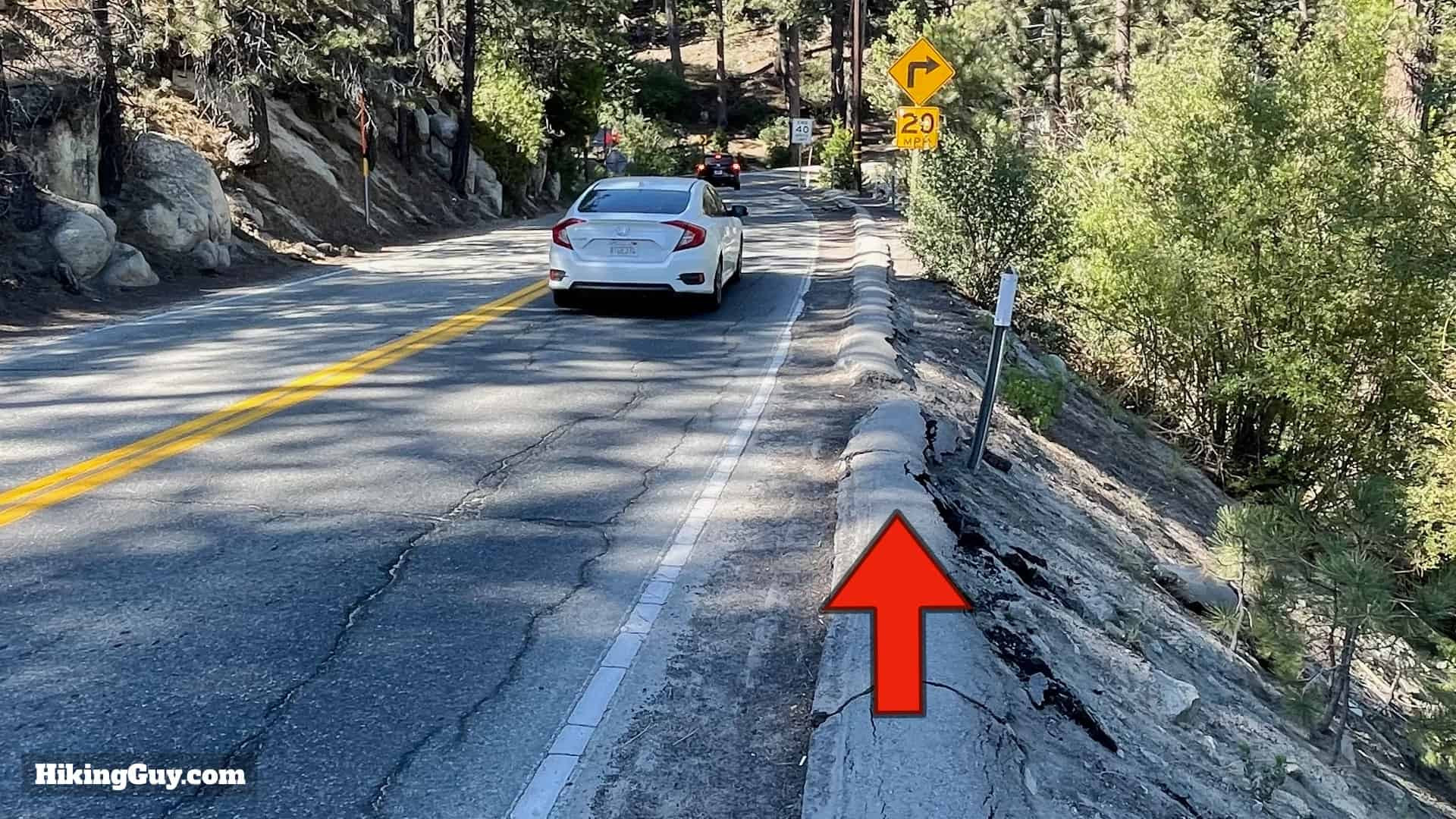 Hikers walking cautiously along Big Bear Boulevard to access Castle Rock Trail