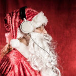 Christmas Santa listening to rock music on headphones