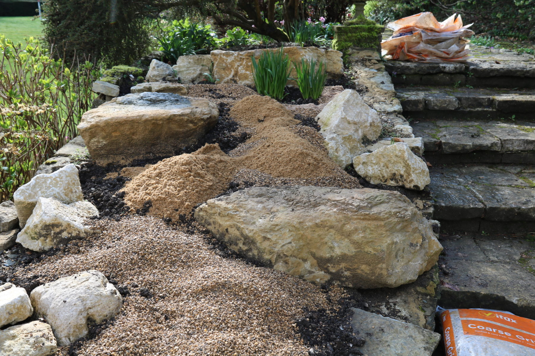 Digging in sand and gravel to improve soil drainage