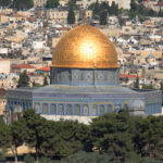 Close up view of the Dome of the Rock's detailed mosaics and Arabic inscriptions, highlighting Byzantine artistic influence.