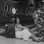 Bride in white dress holding bouquet at Red Rock Lanes bowling alley elopement