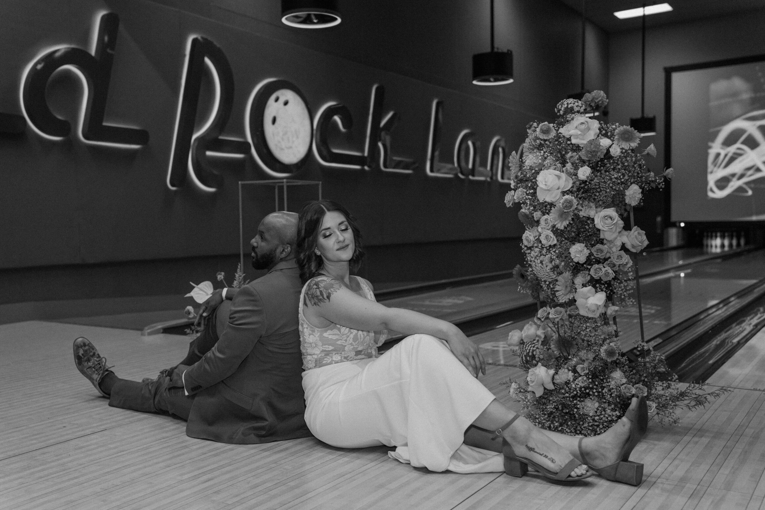 Bride in white dress holding bouquet at Red Rock Lanes bowling alley elopement