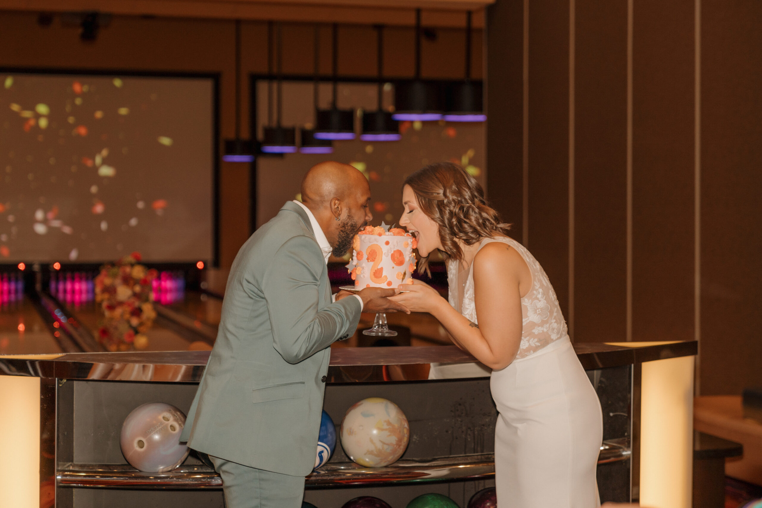 Eloping couple kissing in front of Red Rock Lanes entrance