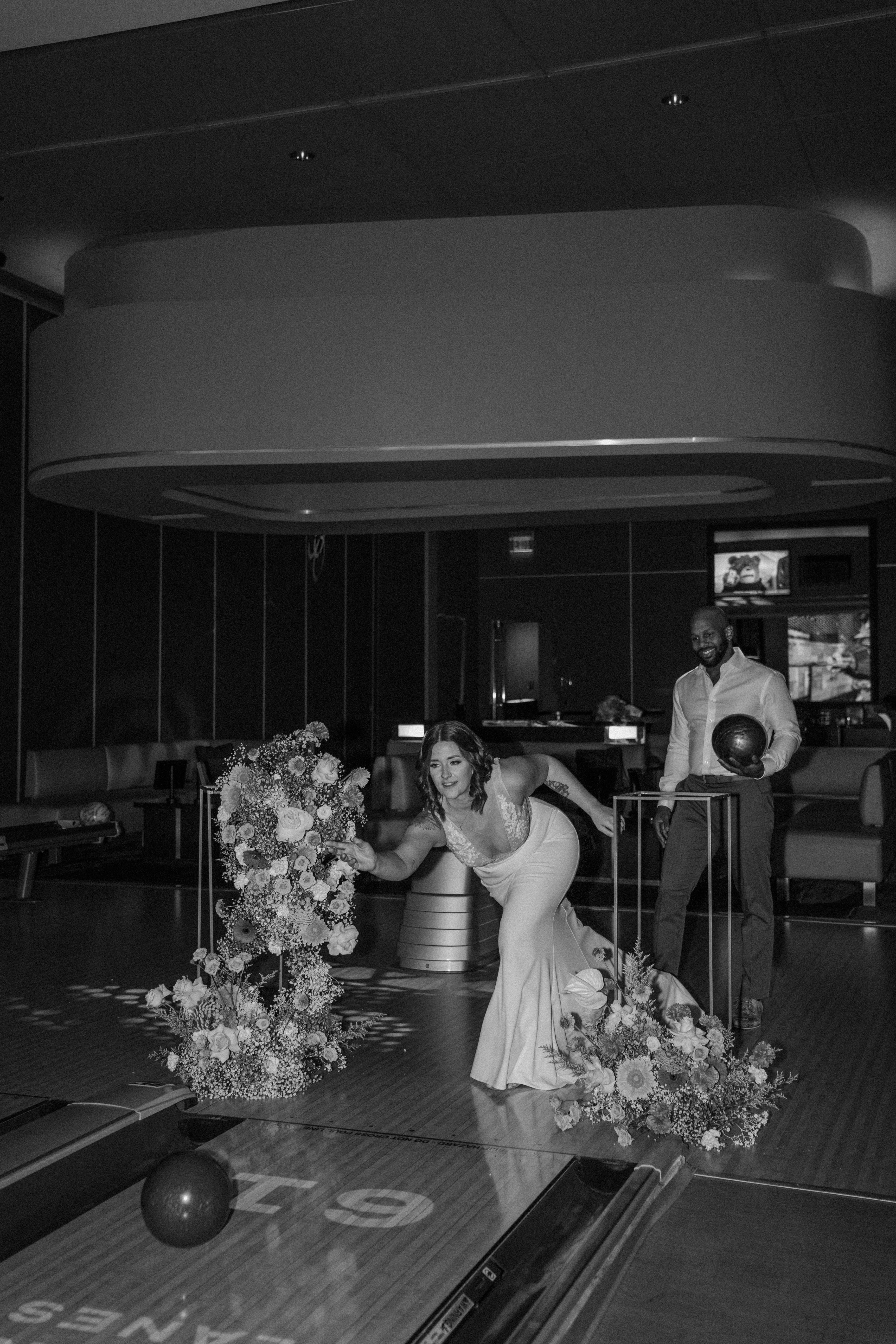 Bride and groom sitting and talking on bowling lane at Red Rock Lanes