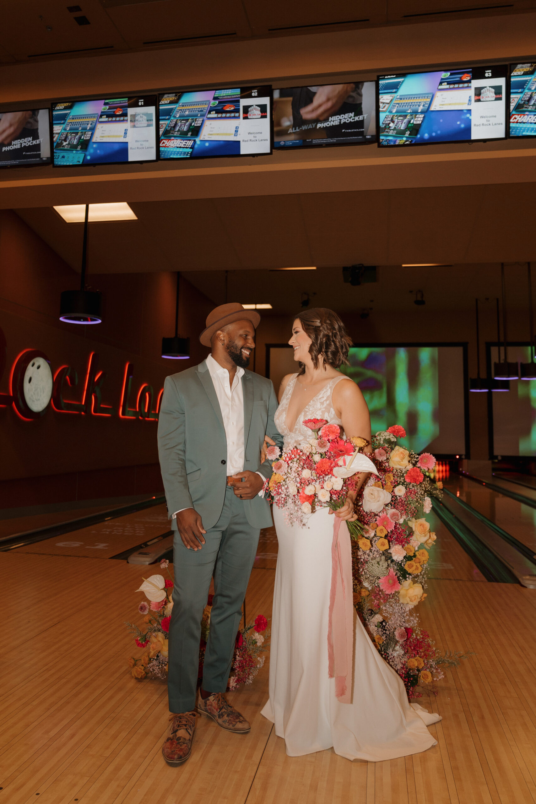 Groom in blue suit and floral shoes at bowling alley elopement, Red Rock Lanes