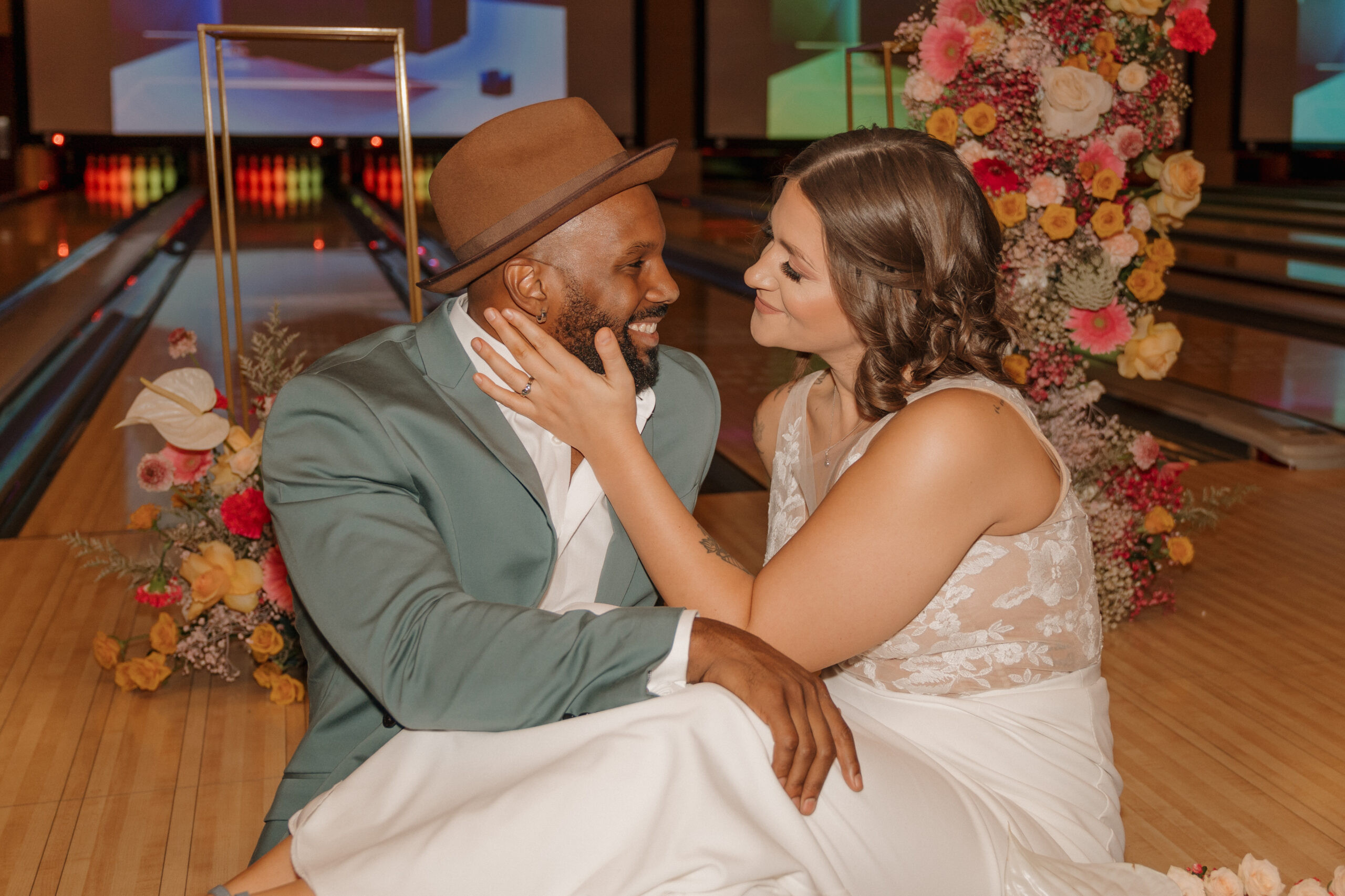 Bride and groom laughing and posing at Red Rock Lanes bowling alley