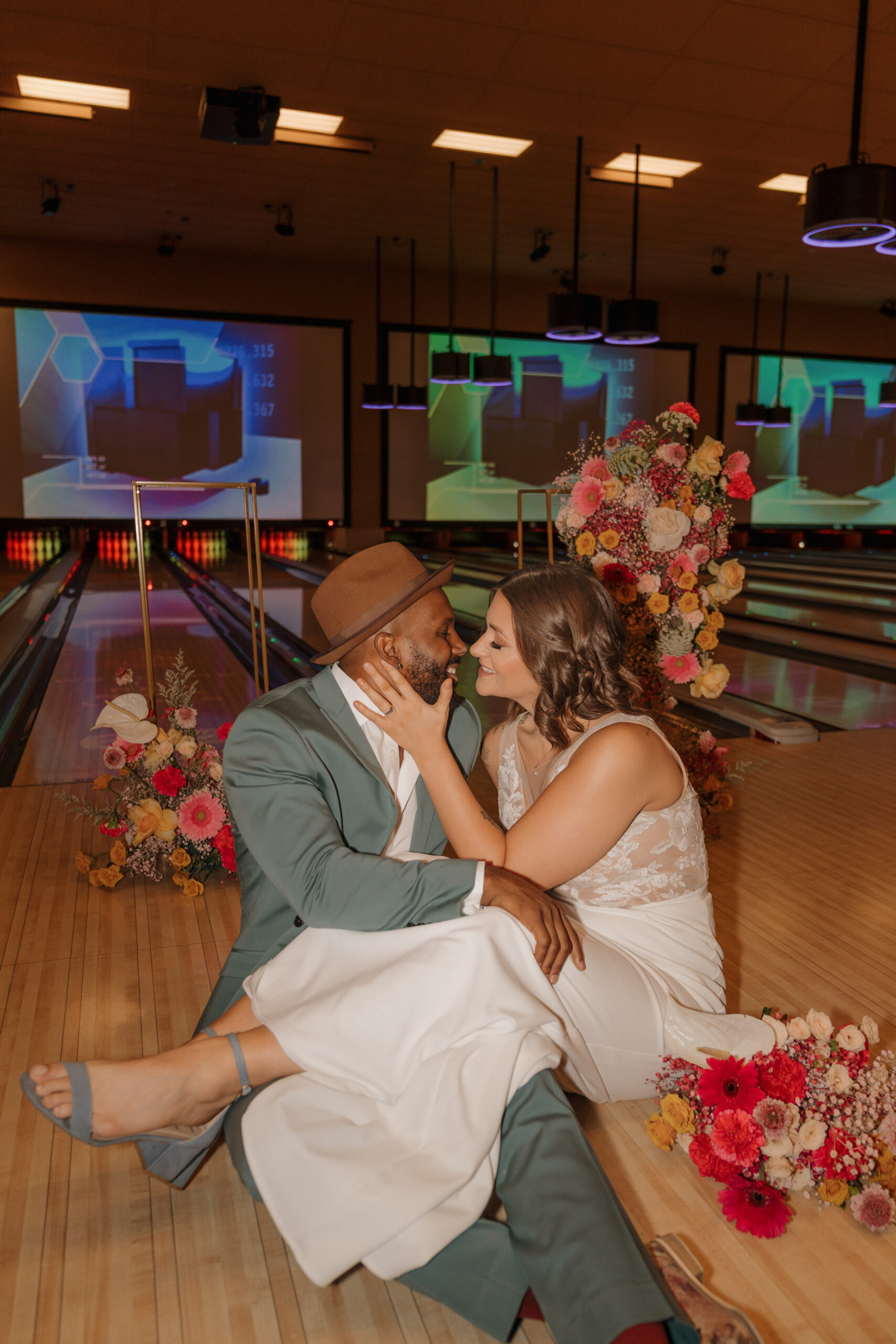 Bride and groom sitting and talking in VIP suite at Red Rock Lanes