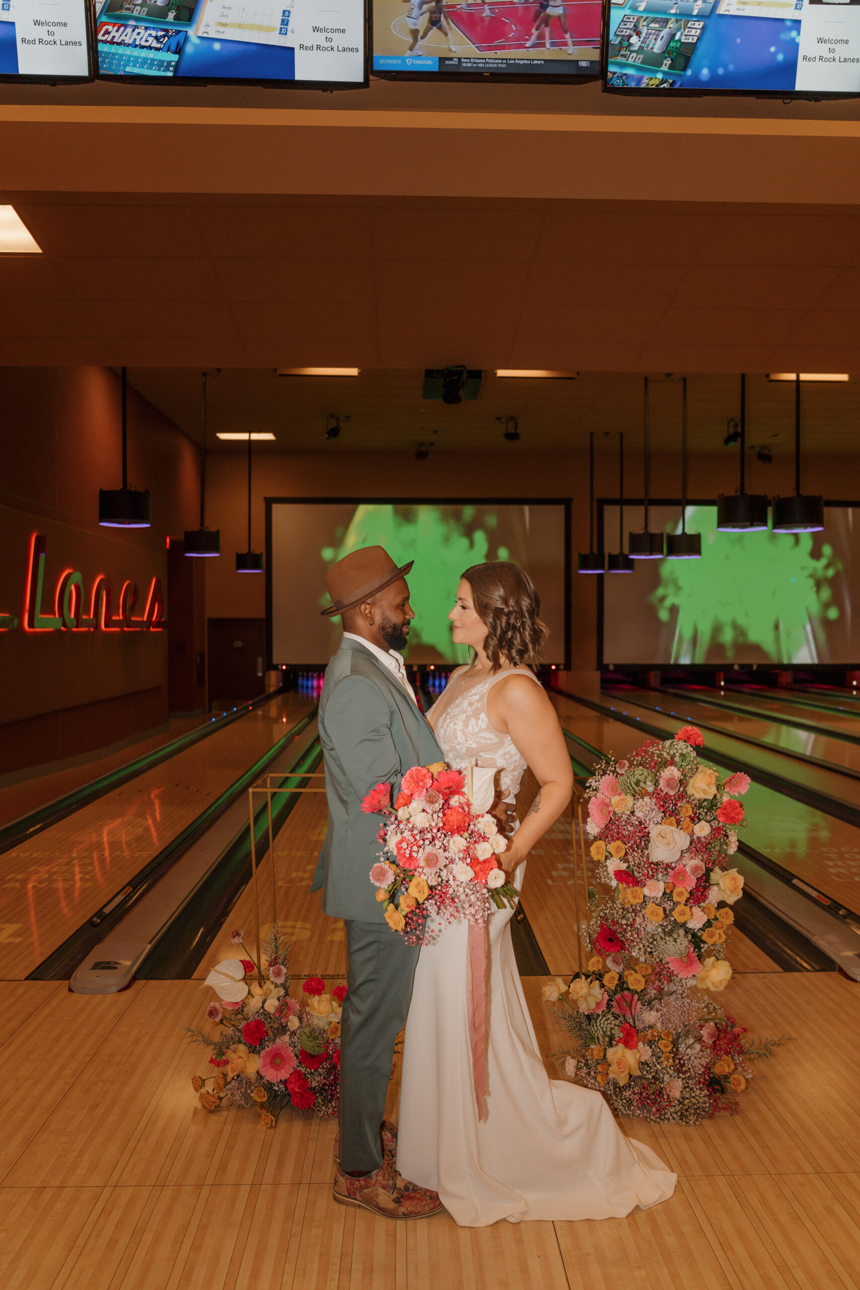 Bride and groom sitting and smiling at Red Rock Lanes bowling alley