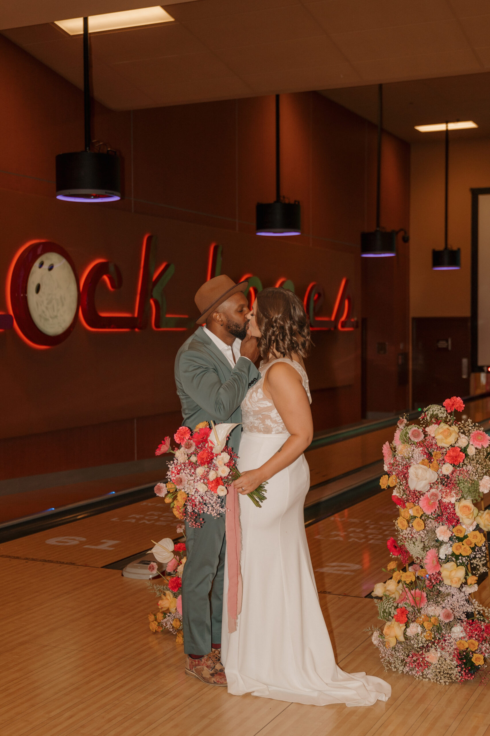 Bride laughing and holding bouquet at Red Rock Lanes elopement