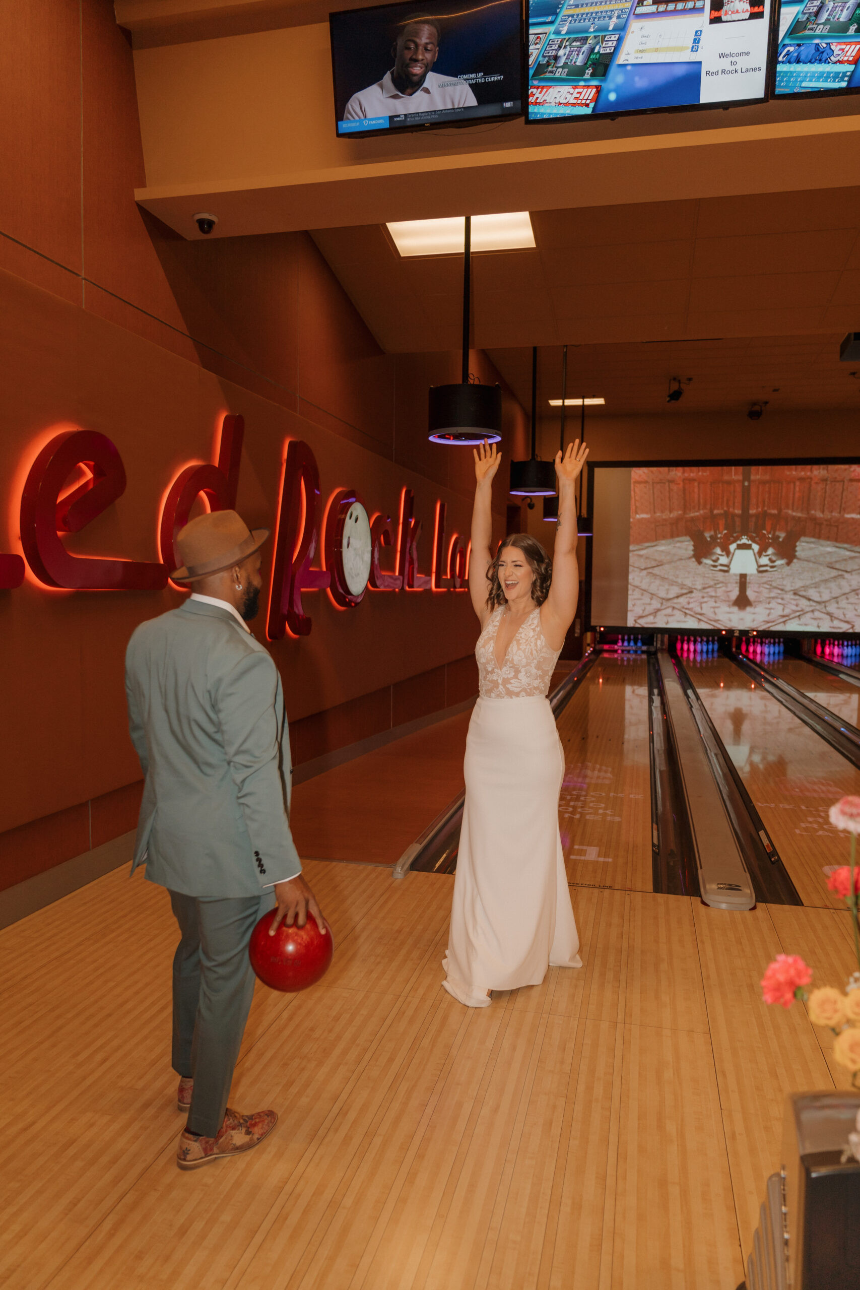 Wide shot of Red Rock Lanes bowling alley VIP suite with eloping couple