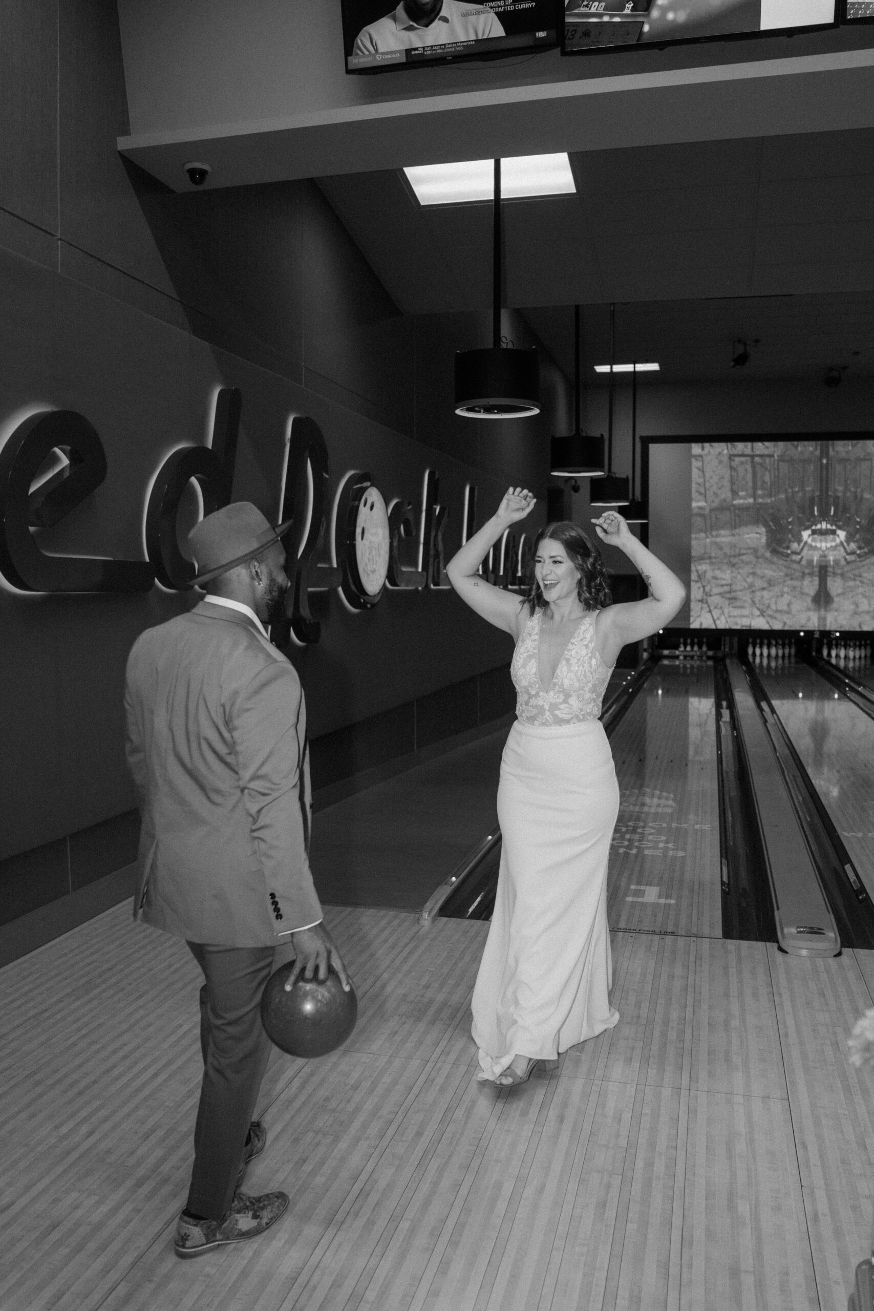 Close up of bride and groom holding hands in Red Rock Lanes VIP suite