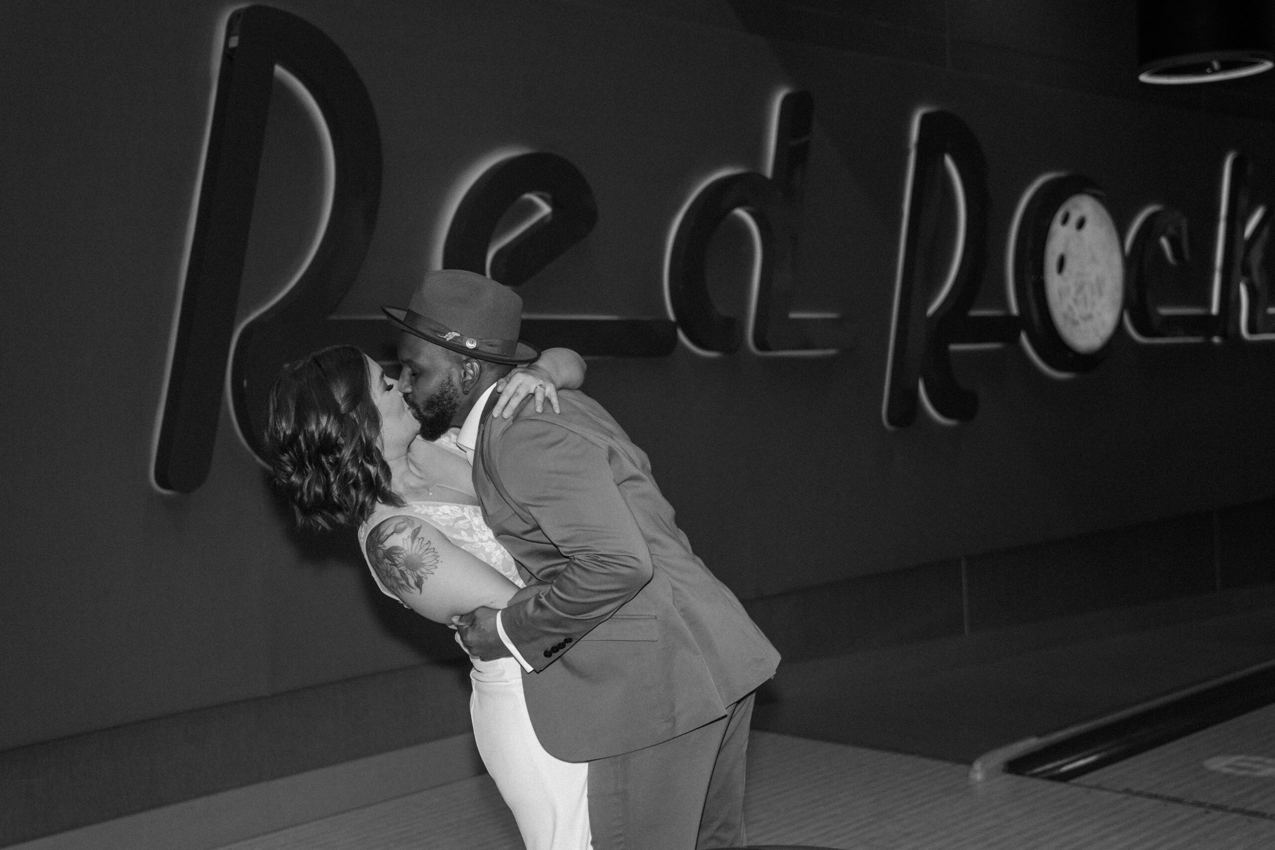 Bride and groom toasting drinks in Red Rock Lanes VIP suite