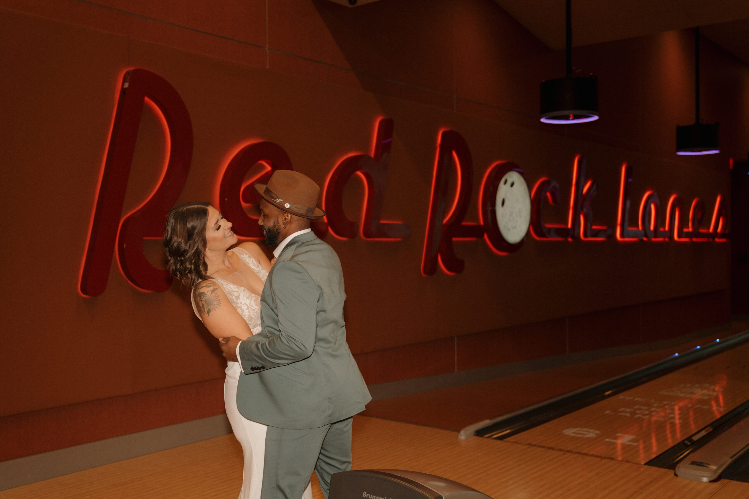 Eloping couple playing arcade games at Red Rock Lanes