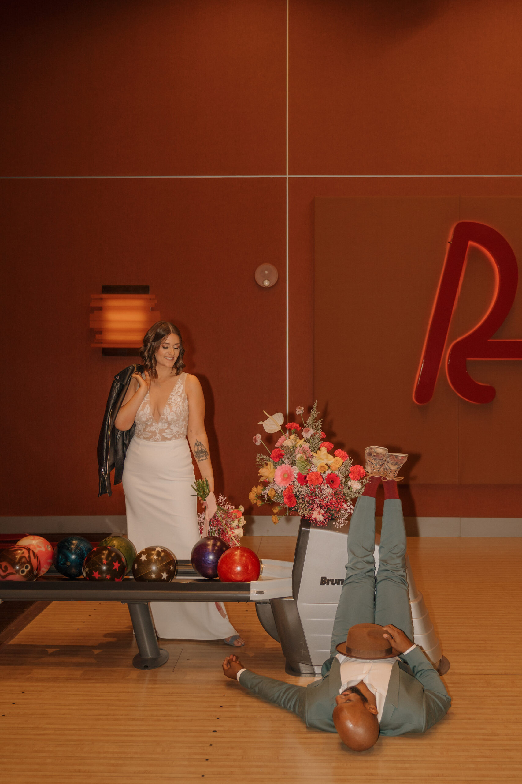 Bride and groom playing ski ball at Red Rock Lanes arcade