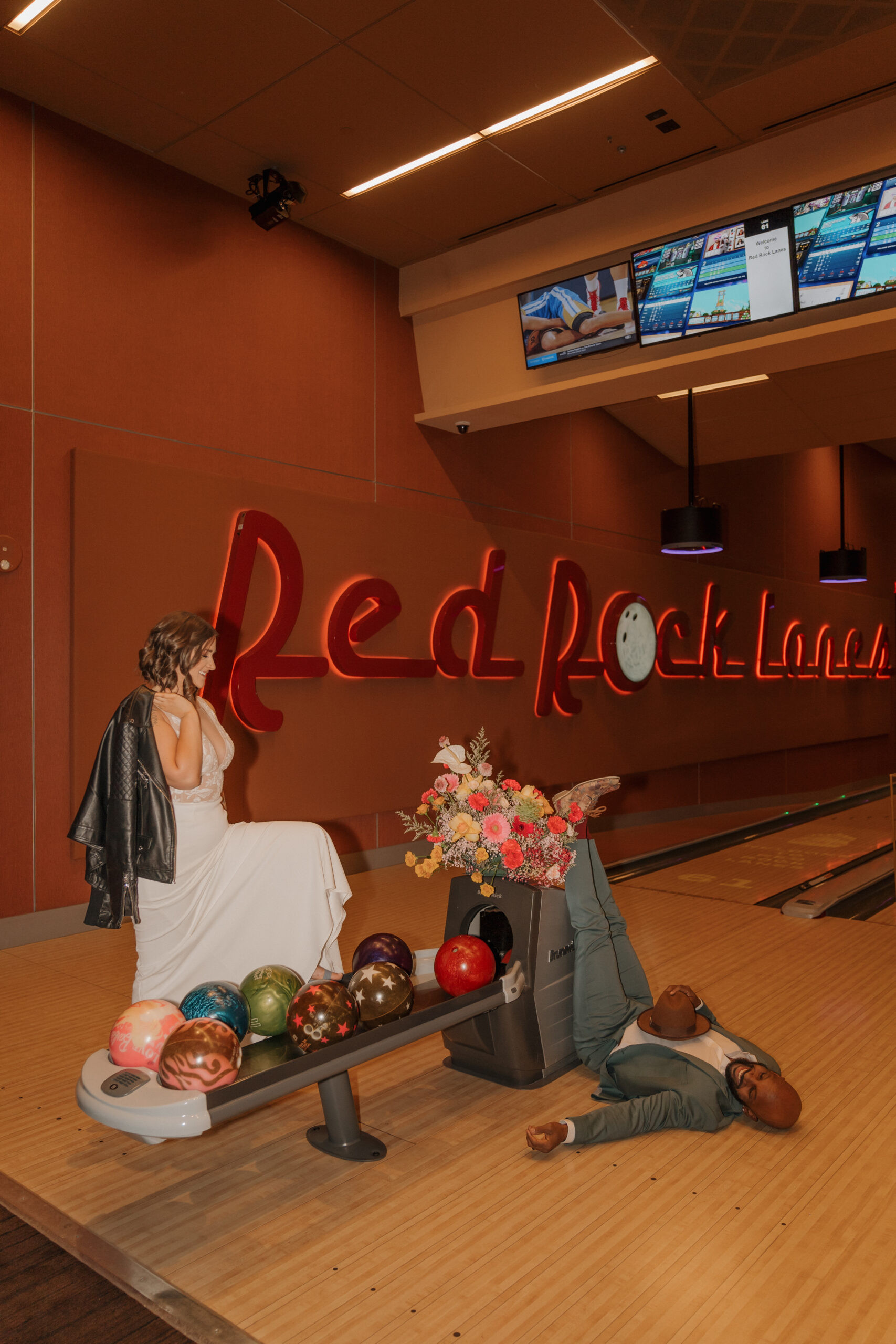 Bride and groom playing air hockey at Red Rock Lanes arcade