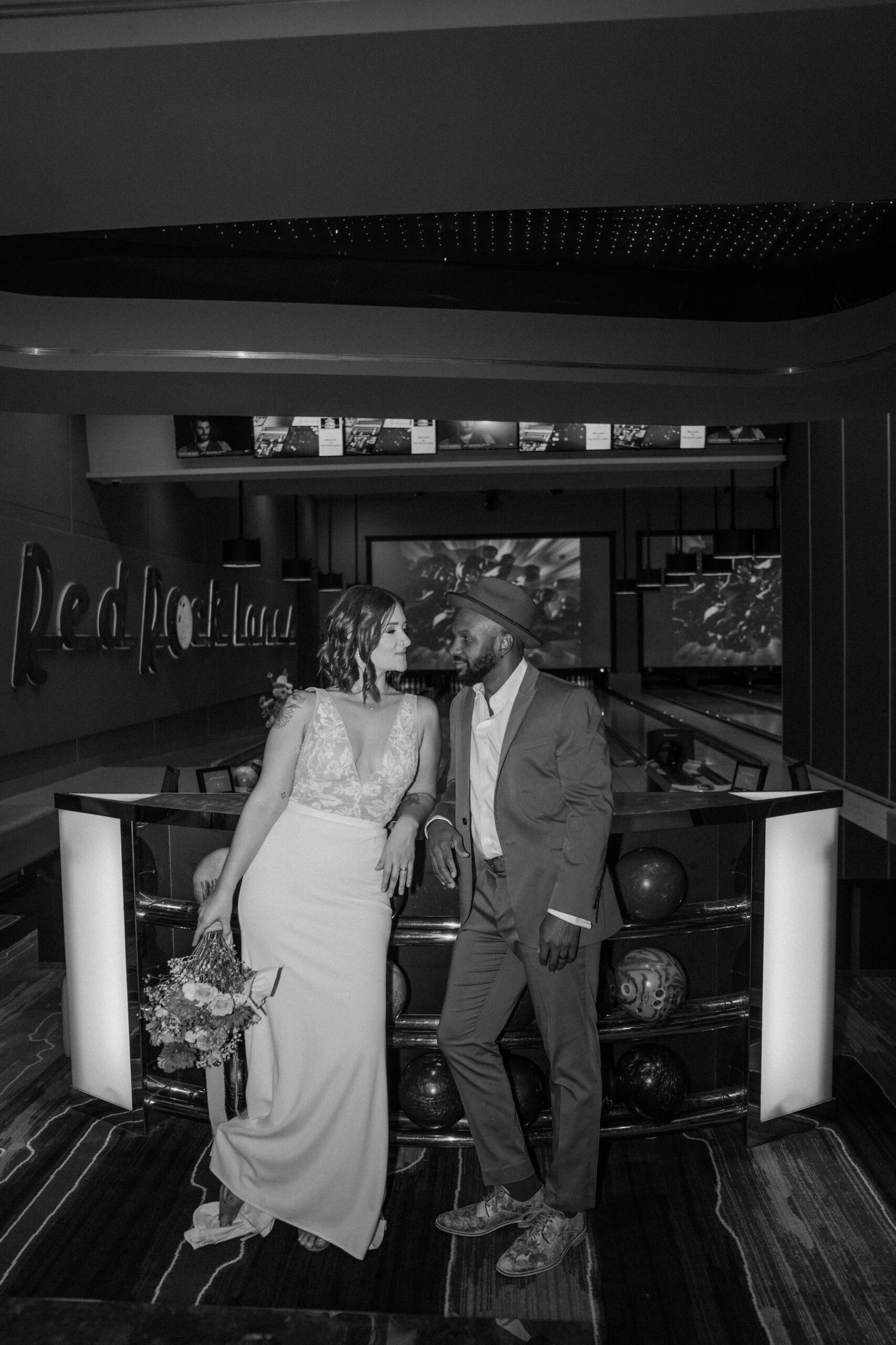 Bride and groom sharing popcorn at Red Rock Lanes arcade