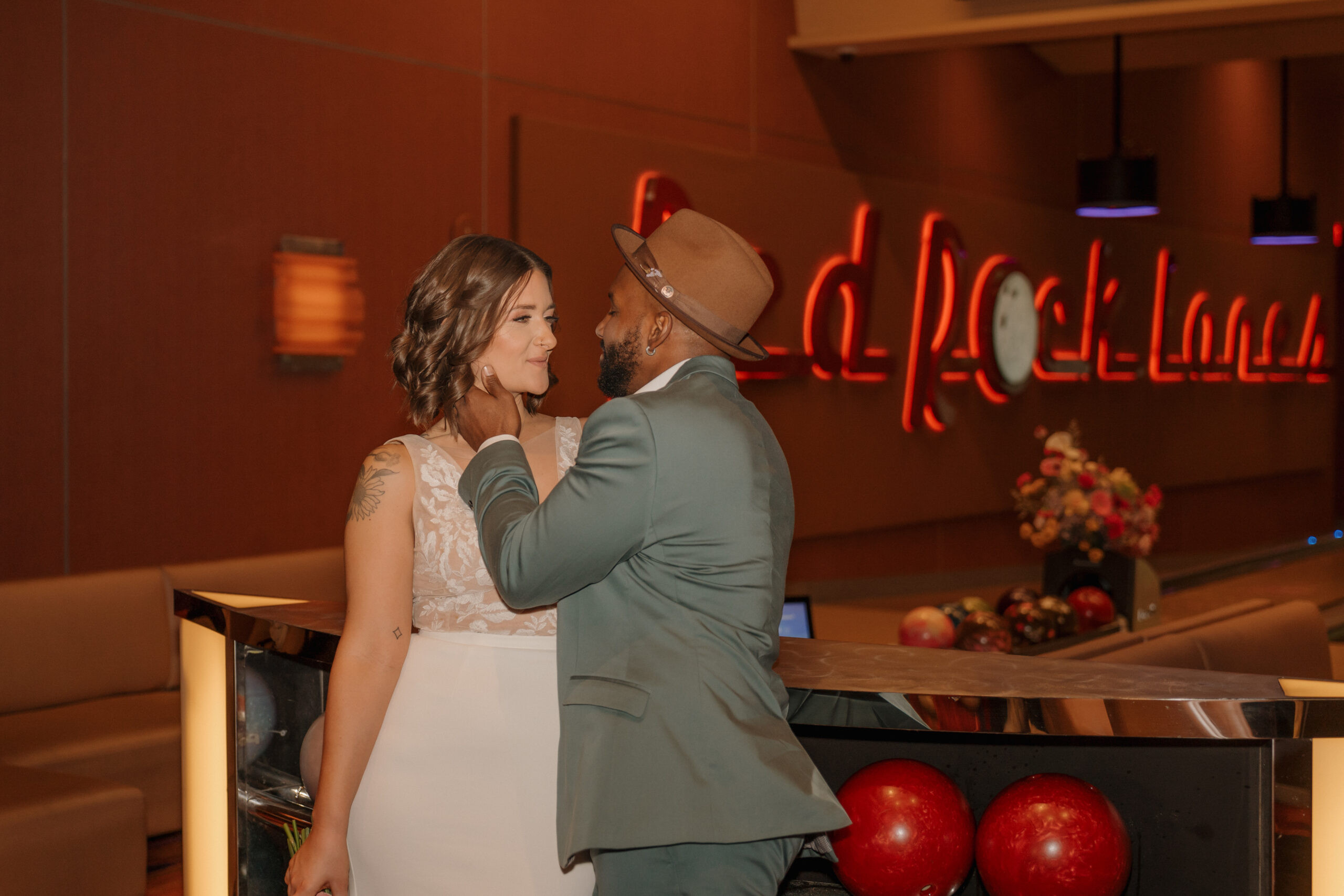 Bride and groom playing claw machine game at Red Rock Lanes arcade