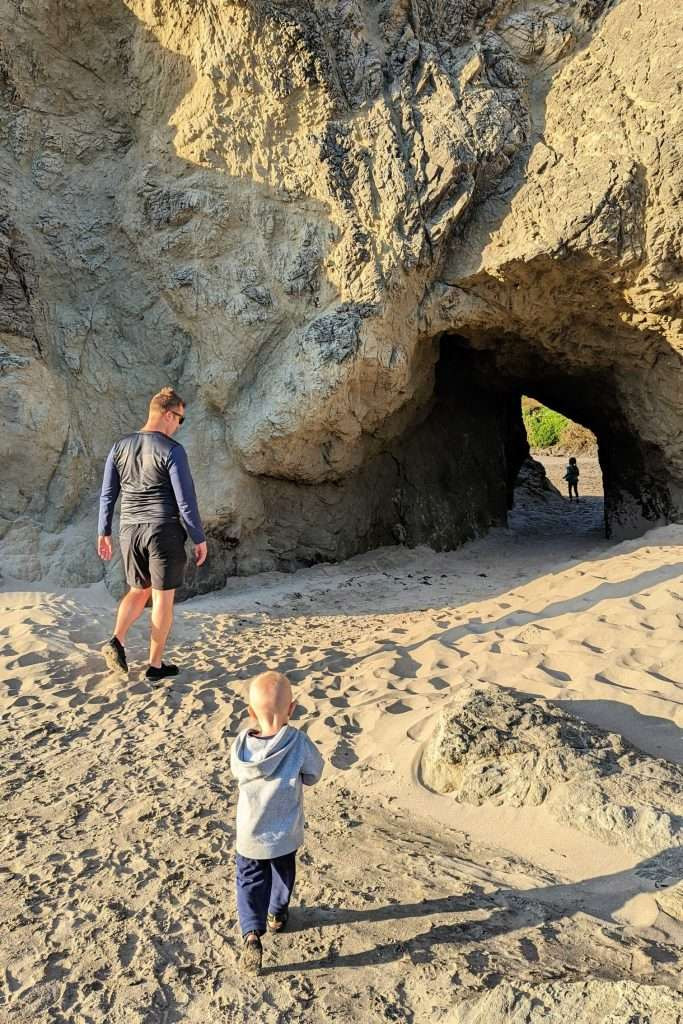 Children playing in the sand and exploring caves at Face Rock beach