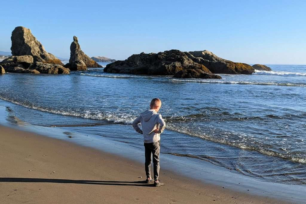 Family adventure exploring the intertidal caves at Face Rock Scenic Viewpoint