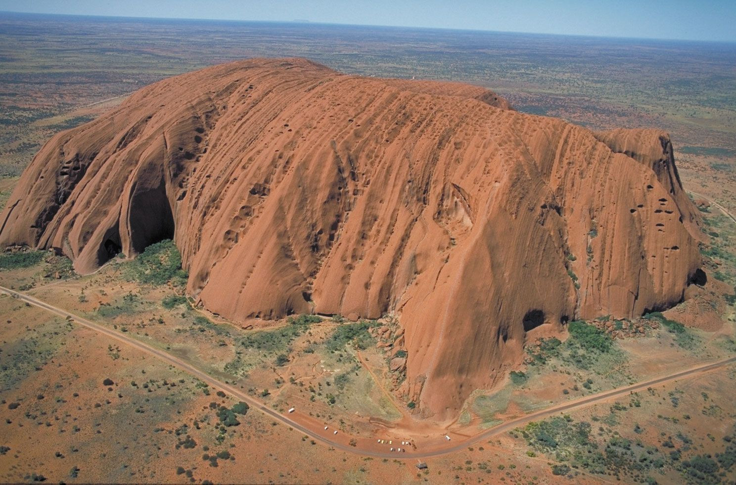 The textured face of Uluru/Ayers Rock, highlighting the sandstone composition and weathering patterns