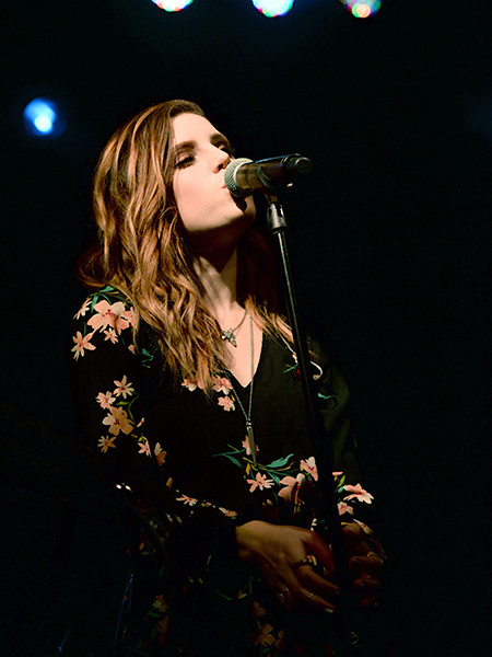 Sydney Sierota of Echosmith performing, alt text: Sydney Sierota, frontwoman of Echosmith, leads her siblings in a lively indie-pop performance.