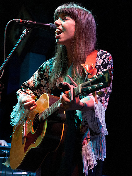 Alynda Lee Segarra of Hurray for the Riff Raff performing, alt text: Alynda Lee Segarra of Hurray for the Riff Raff, Americana singer-songwriter, performs folk-infused music.